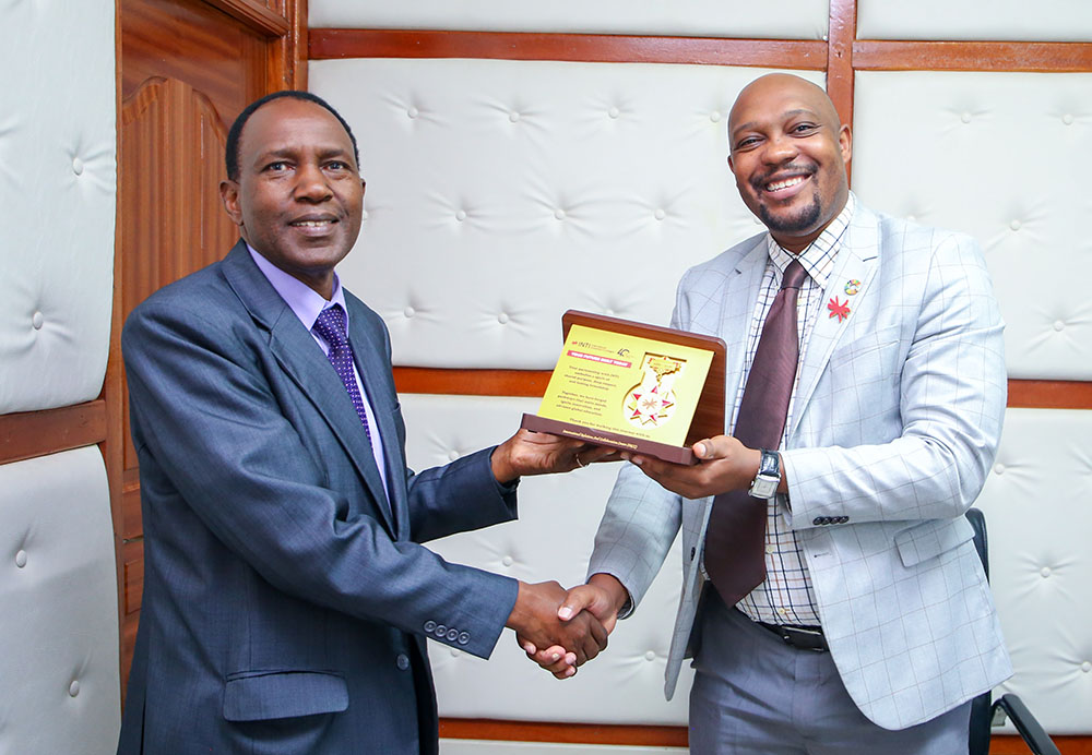 INTI International University, Global Relations Manager, Dr. Mayibongwe Tafara Mudzengi (Right) hands a partnership plaque to DVC, IEA, Prof. Paul Wambua